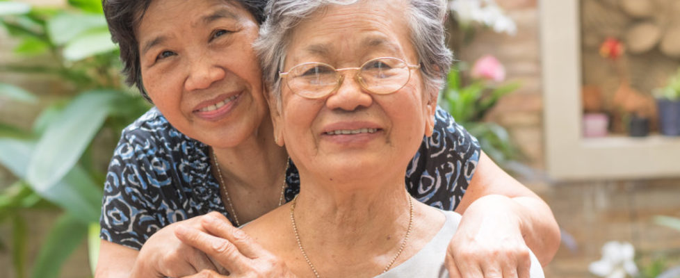 Happy senior friendship society concept. Portrait of Asian female older ageing women smiling with happiness in garden at home, nursing home, or wellbeing county