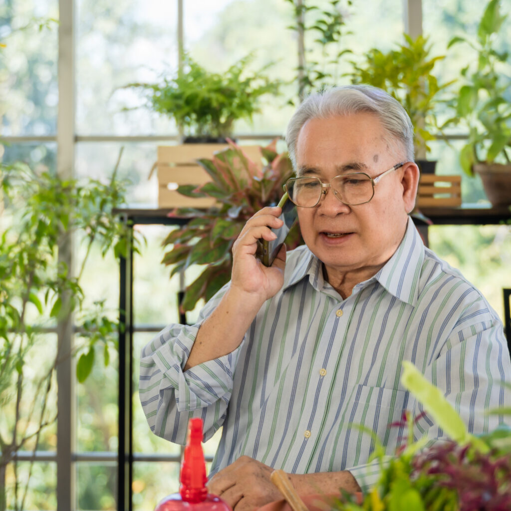 Man surrounded by indoor plants